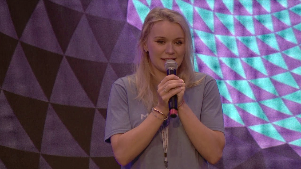 Victoria speaking on stage